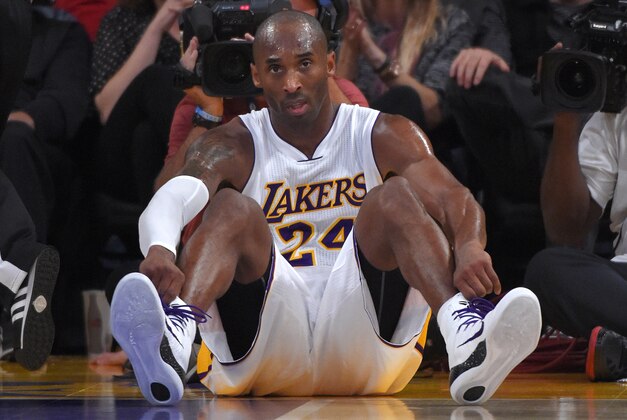 Los Angeles Lakers guard Kobe Bryant sits on the floor after being fouled during the second half of an NBA basketball game against the Golden State Warriors, Sunday, Nov. 16, 2014, in Los Angeles. The Warriors won 136-115. (AP Photo/Mark J. Terrill)