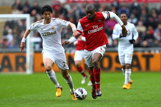 SWANSEA, WALES - MARCH 16:   Abou Diaby of Arsenal battles with Ki Sung-Yueng of Swansea City during the Barclays Premier League match between Swansea City and Arsenal at Liberty Stadium on March 16, 2013 in Swansea, Wales.  (Photo by Jan Kruger/Getty Images)