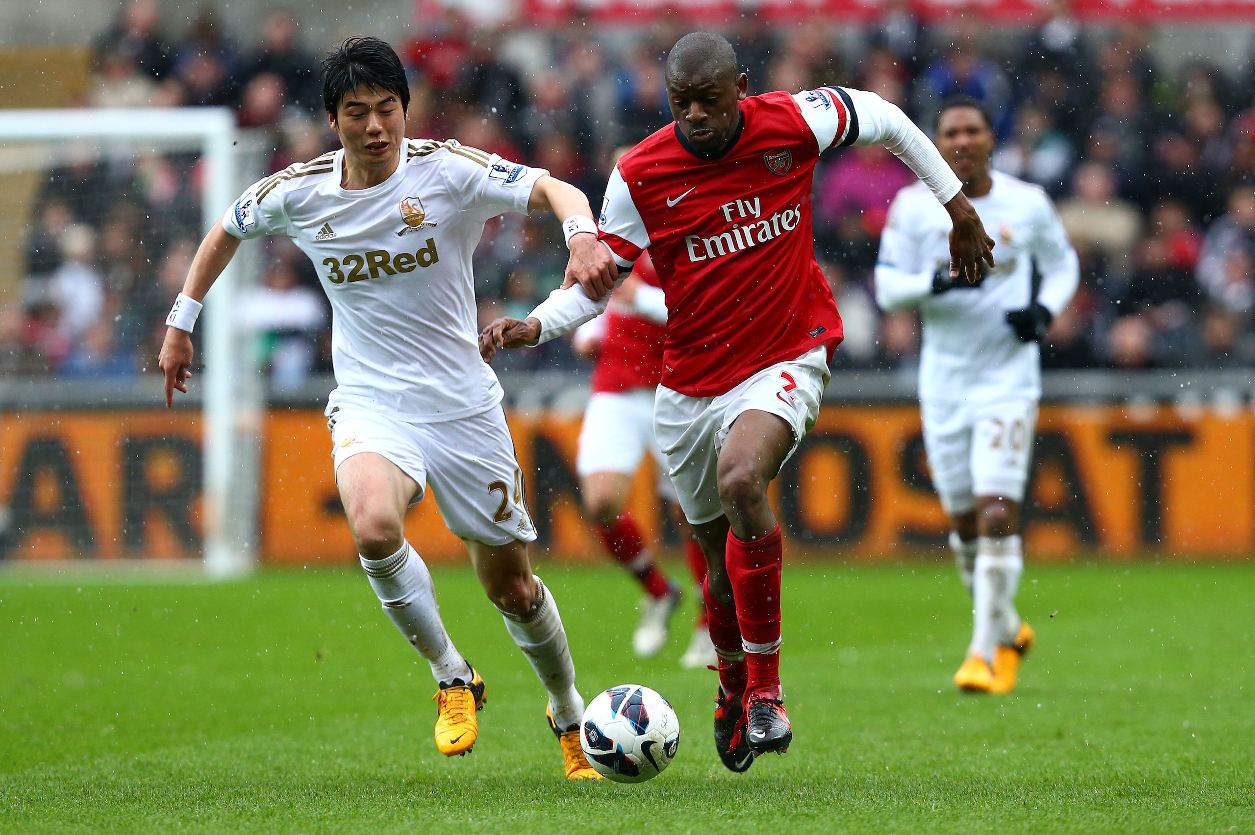 SWANSEA, WALES - MARCH 16:   Abou Diaby of Arsenal battles with Ki Sung-Yueng of Swansea City during the Barclays Premier League match between Swansea City and Arsenal at Liberty Stadium on March 16, 2013 in Swansea, Wales.  (Photo by Jan Kruger/Getty Images)
