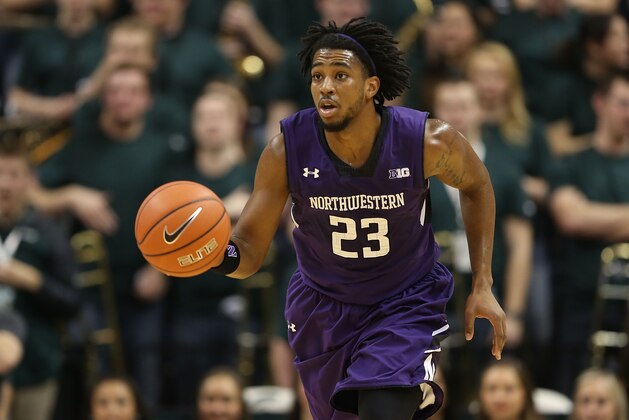 EAST LANSING, MI - FEBRUARY 13:  JerShon Cobb #23 of the Northwestern Wildcats brings the ball up the court during the first half of the game against the Michigan State Spartans at the Breslin Center on February 13, 2014 in East Lansing, Michigan.  (Photo by Leon Halip/Getty Images)