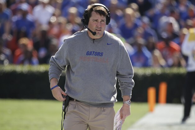 Florida head coach Will Muschamp  walks the sidelines during the first half of an NCAA college football game against South Carolina in Gainesville, Fla., Saturday, Nov. 15, 2014. (AP Photo/John Raoux)