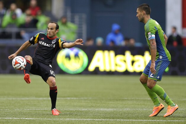 Los Angeles Galaxy's Landon Donovan, left, controls the ball as Seattle Sounders forward Clint Dempsey, right, looks on in the second half of an MLS soccer match, Saturday, Oct. 25, 2014, in Seattle. The Sounders beat the Galaxy 2-0. (AP Photo/Ted S. Warren)