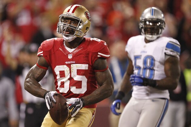 San Francisco 49ers tight end Vernon Davis, left, after scoring a touchdown during the fourth quarter of an NFL football game against the Detroit Lions in San Francisco, Sunday, Sept. 16, 2012. At right is Detroit Lions linebacker Ashlee Palmer. (AP Photo/Tony Avelar)