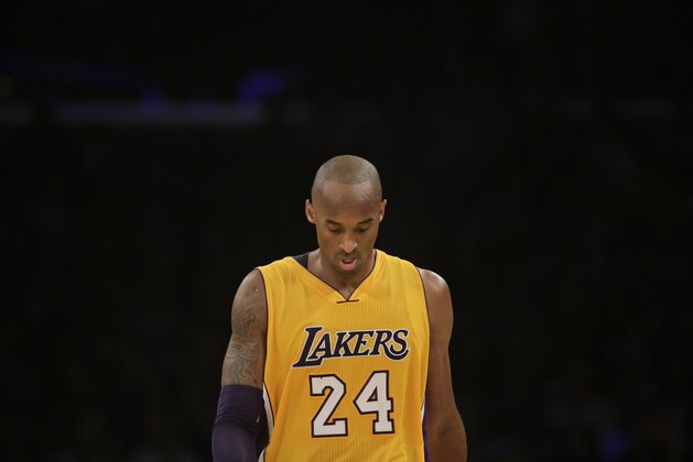 Los Angeles Lakers' Kobe Bryant walks along the court during the second half of an NBA basketball game against the San Antonio Spurs Friday, Nov. 14, 2014, in Los Angeles. The Spurs won 93-80. (AP Photo/Jae C. Hong)