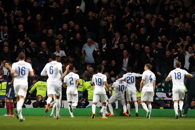 England's captain Wayne Rooney, center, celebrates his goal with teammates, during the international friendly soccer match between Scotland and England,  at Celtic Park, Glasgow, Scotland, Tuesday Nov. 18, 2014. (AP Photo/Scott Heppell)
