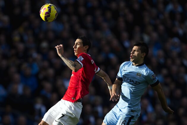 Manchester City's Sergio Aguero, right, fights for the ball against  Manchester United's Angel Di Maria during their English Premier League soccer match at the Etihad Stadium, Manchester, England, Sunday Nov. 2, 2014. (AP Photo/Jon Super)