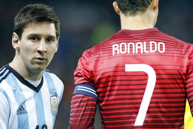 Lionel Messi of Argentina, left, stands next to Cristiano Ronaldo of Portugal before their International Friendly soccer match at Old Trafford Stadium, Manchester, England, Tuesday Nov. 18, 2014. (AP Photo/Jon Super)