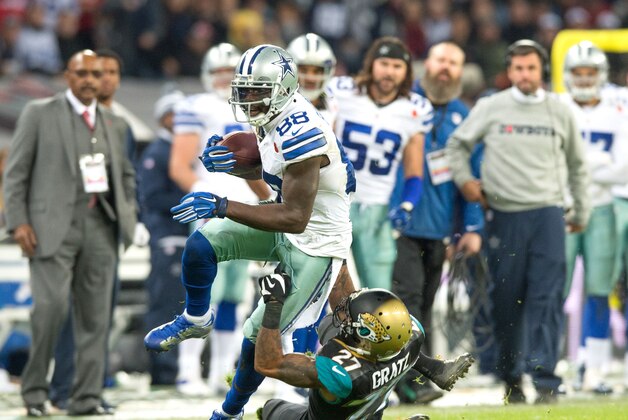 Nov 9, 2014; London, UNITED KINGDOM; Jacksonville Jaguars cornerback Dwayne Gratz (27) dives in vain as Dallas Cowboys wide receiver Dez Bryant (88) catches a touchdown pass during the first half of the game Dallas Cowboys and the Jacksonville Jaguars at Wembley Stadium Mandatory Credit: Steve Flynn-USA TODAY Sports