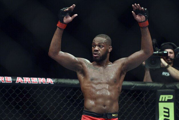 Apr 26, 2014; Baltimore, MD, USA;  Jon Jones puts his arms in the air after the UFC light heavy weight championship fight against Glover Texeira at  Baltimore Arena. Jones retained the light heavy height championship by defeating  Teixeria.  Mandatory Credit: Tommy Gilligan-USA TODAY Sports