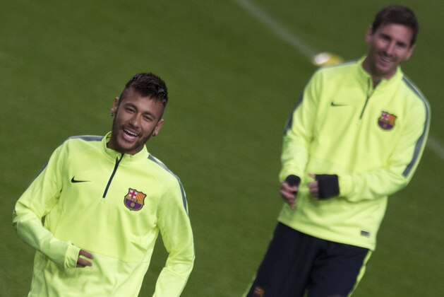 Barcelona's Neymar, left, and Barcelona's Lionel Messi, right, laugh as they warmup during a training at ArenA stadium in Amsterdam, Netherlands, Tuesday, Nov. 4, 2014, one day ahead of the Group F Champions League match between AFC Ajax and FC Barcelona. (AP Photo/Peter Dejong)