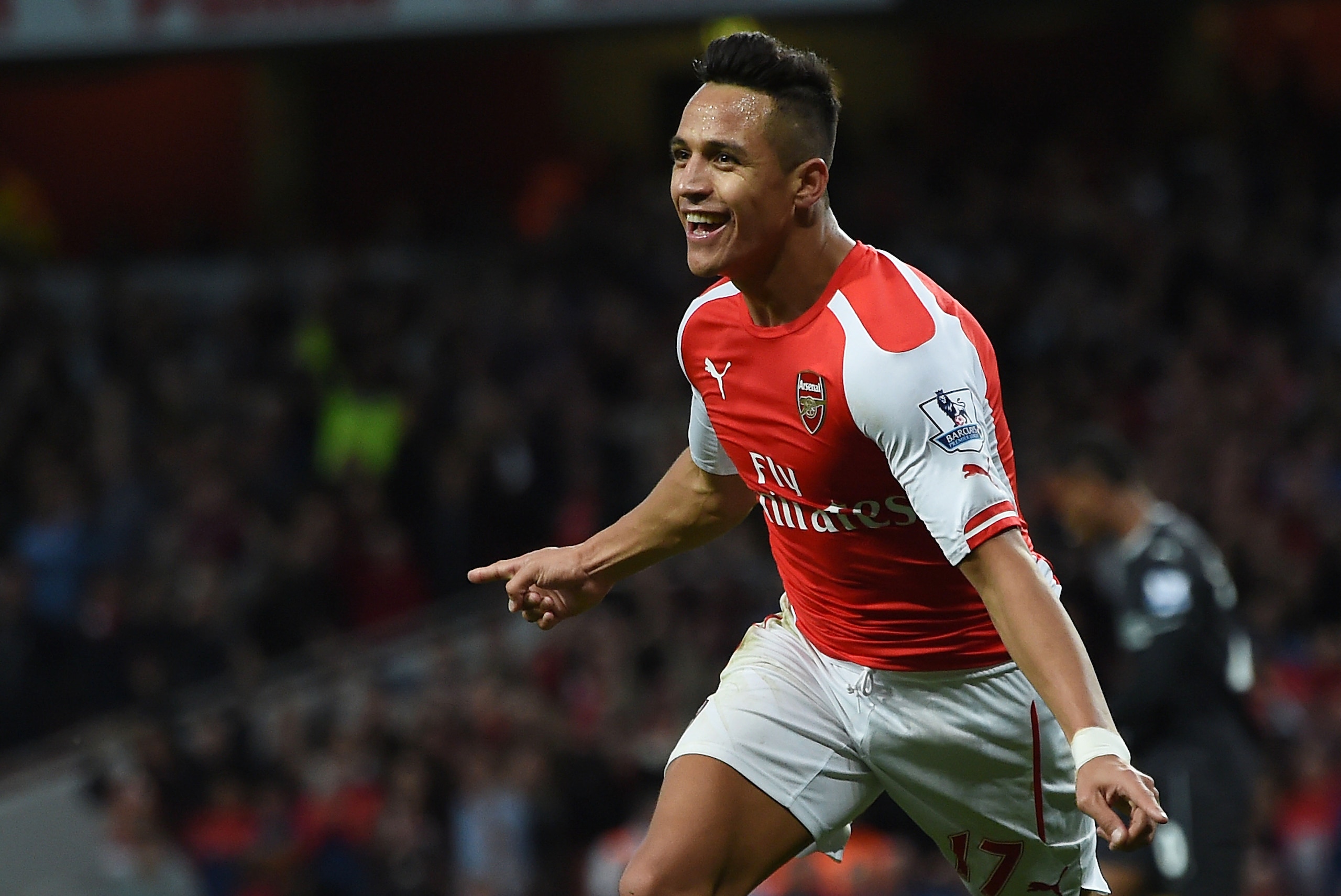 Arsenal’s Alexis Sanchez celebrates scoring his side's third goal against Burnley during their English Premier League soccer match at the Emirates stadium, London, Saturday, Nov. 1, 2014. (AP Photo/Tim Ireland)