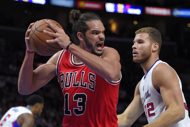 Chicago Bulls center Joakim Noah, left, grabs a rebound away from Los Angeles Clippers forward Blake Griffin during the first half of an NBA basketball game, Monday, Nov. 17, 2014, in Los Angeles.  (AP Photo/Mark J. Terrill)