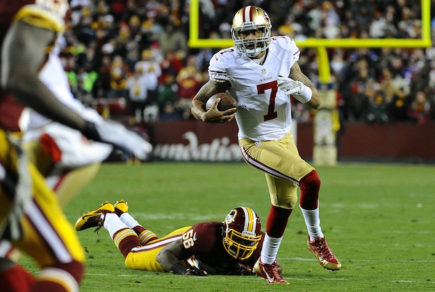 Nov 25, 2013; Landover, MD, USA; San Francisco 49ers quarterback Colin Kaepernick (7) runs as Washington Redskins linebacker Perry Riley (56) looks on during the first half at FedEx Field. Mandatory Credit: Brad Mills-USA TODAY Sports