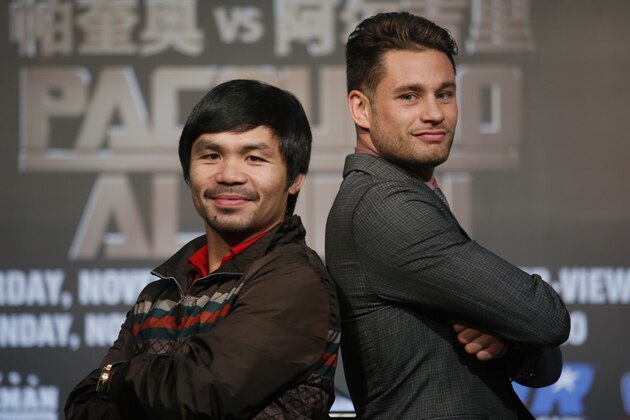 WBO Welterweight champion Manny Pacquiao, left, of the Philippines, and WBO junior welterweight champion Chris Algieri of United States, right, pose for photographers during a news conference in Macau, Monday, Aug. 25, 2014. The boxers are scheduled to battle in WBO welterweight title match at The Venetian Macao on Nov. 23 in Macau. (AP Photo/Vincent Yu)
