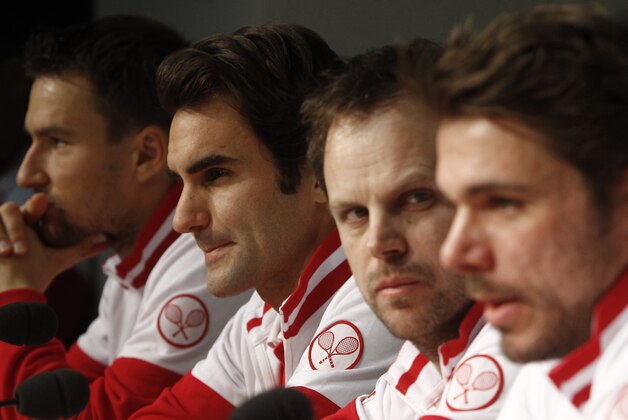 Switzerland's Roger Federer, second left, during the Swiss team media conference at the Pierre Mauroy stadium in Lille, northern France, Tuesday, Nov. 18, 2014. Switzerland will face France in the Davis Cup final starting next Friday. (AP Photo/Michel Spingler)