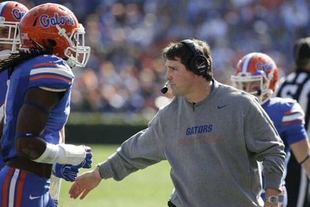 Florida head coach Will Muschamp  encourages his players during the first half of an NCAA college football game against South Carolina in Gainesville, Fla., Saturday, Nov. 15, 2014. (AP Photo/John Raoux)