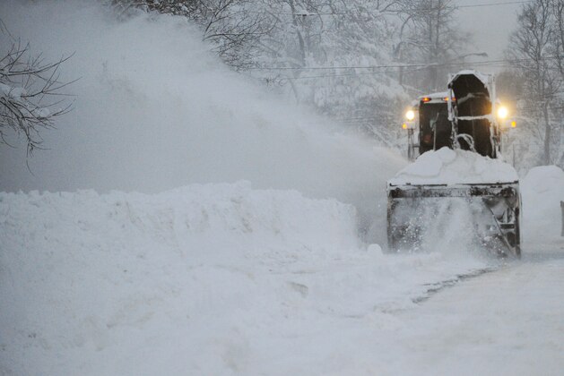 A New York State snowblower removes snow on Broadway in Lancaster,  N.Y. Wednesday, Nov. 19, 2014. A ferocious storm dumped massive piles of snow on parts of upstate New York, trapping residents in their homes and stranding motorists on roadways, as temperatures in all 50 states fell to freezing or below.   (AP Photo/Gary Wiepert)