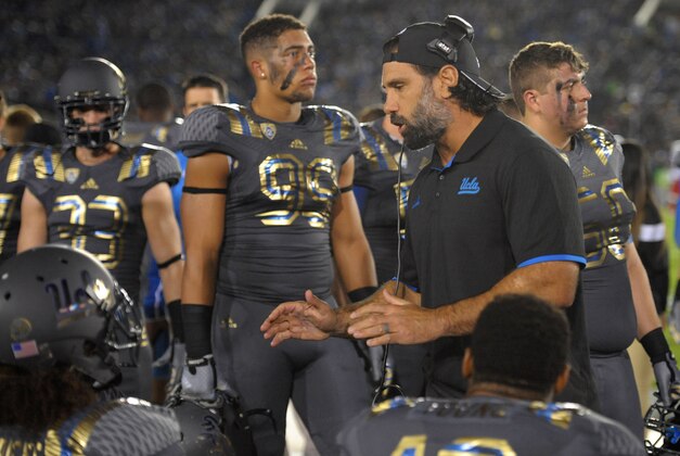 Nov 1, 2014; Pasadena, CA, USA; UCLA Bruins defensive coordinator Jeff Ulbrich (right) talks to his players during the first quarter against the Arizona Wildcats at Rose Bowl. Mandatory Credit: Jake Roth-USA TODAY Sports