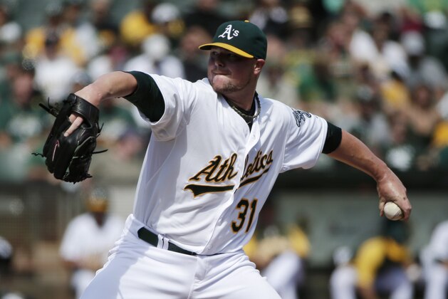 Oakland Athletics starting pitcher Jon Lester throws to the Los Angeles Angels during the first inning of a baseball game on Wednesday, Sept. 24, 2014, in Oakland, Calif. (AP Photo/Marcio Jose Sanchez)