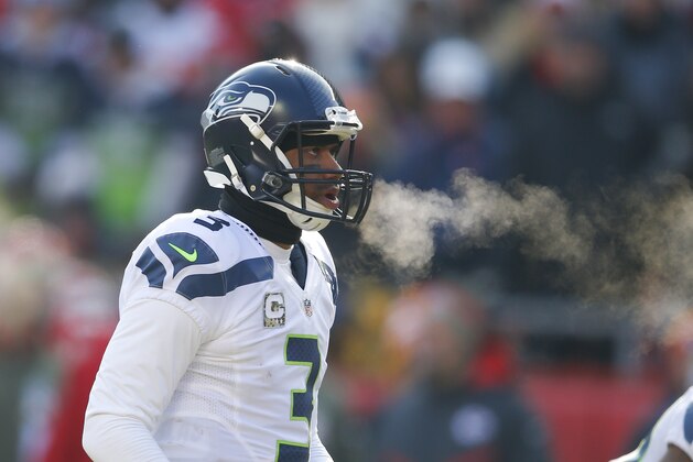 Seattle Seahawks quarterback Russell Wilson (3) exhales in freezing temperatures in the first half of an NFL football game against the Kansas City Chiefs in Kansas City, Mo., Sunday, Nov. 16, 2014. (AP Photo/Ed Zurga)
