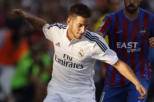 Real Madrid's Medran duels for the ball with Levante's Morales, right, during a Spanish La Liga soccer match at the Ciutat de Valencia stadium in Valencia, Spain, on Saturday, Oct. 18, 2014. (AP Photo/Alberto Saiz)