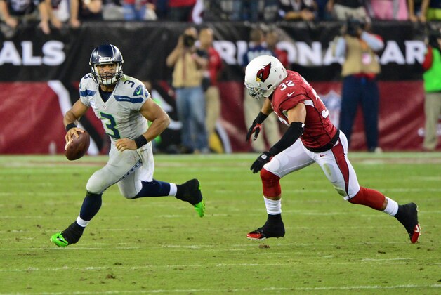 Oct 17, 2013; Phoenix, AZ, USA; Seattle Seahawks quarterback Russell Wilson (3) runs from Arizona Cardinals free safety Tyrann Mathieu (32) during the first half at University of Phoenix Stadium. Mandatory Credit: Matt Kartozian-USA TODAY Sports