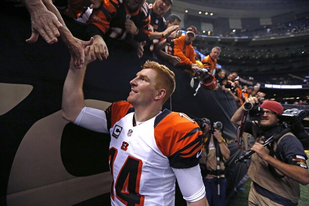 Cincinnati Bengals quarterback Andy Dalton (14) greets fans after their NFL football game against the New Orleans Saints in New Orleans, Sunday, Nov. 16, 2014. The Bengals won 27-10. (AP Photo/Rogelio Solis)