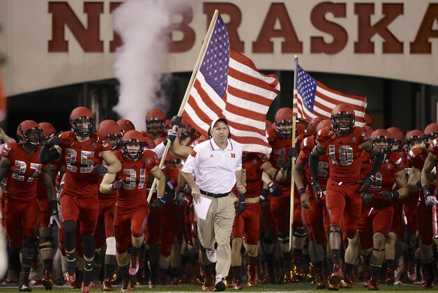 Nebraska head coach Bo Pelini leads his players onto the field before the first half of an NCAA college football game against Illinois in Lincoln, Neb., Saturday, Sept. 27, 2014. (AP Photo/Nati Harnik)