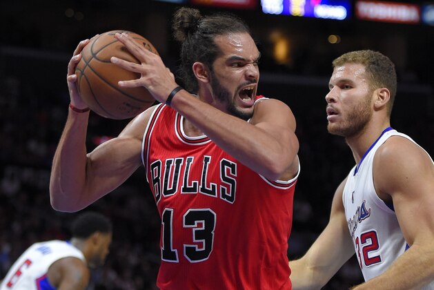 Chicago Bulls center Joakim Noah, left, grabs a rebound away from Los Angeles Clippers forward Blake Griffin during the first half of an NBA basketball game, Monday, Nov. 17, 2014, in Los Angeles.  (AP Photo/Mark J. Terrill)