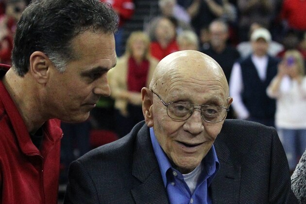 FILE - In this March 1, 2014 file photo, Jerry Tarkanian is escorted by his son, Danny, during halftime ceremonies honoring their former coach at Fresno State University in Fresno, Calif. Hall of Famer Jerry Tarkanian has been admitted to a Las Vegas hospital after relatives say he was feeling weak and having trouble breathing.  Tarkanian's son, Danny, says his 83-year-old father was also struggling to keep his eyes open when he was taken to Valley Hospital on Wednesday night, April 9, 2014. The elder Tarkanian remained sedated at the hospital Thursday morning  (AP Photo/Gary Kazanjian, File)