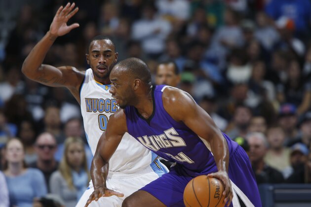 Sacramento Kings forward Carl Landry, front, works ball inside for shot as Denver Nuggets forward Darrell Arthur covers in the third quarter of the Kings' 110-105 victory in an NBA basketball game in Denver on Monday, Nov. 3, 2014. (AP Photo/David Zalubowski)