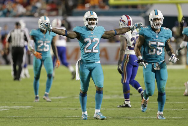 Miami Dolphins cornerback Jamar Taylor (22) celebrates after a play during the final minutes of the second half of an NFL football game against the Buffalo Bills, Friday, Nov. 14, 2014 in Miami Gardens, Fla. The Dolphins defeated the Bills 22-9. (AP Photo/Lynne Sladky)