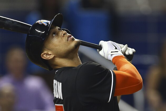 Miami Marlins batter Giancarlo Stanton watches his ball after hitting a pop-up foul during the first inning of a baseball game in Miami against the Atlanta Braves, Saturday, Sept. 6, 2014.  (AP Photo/J Pat Carter)