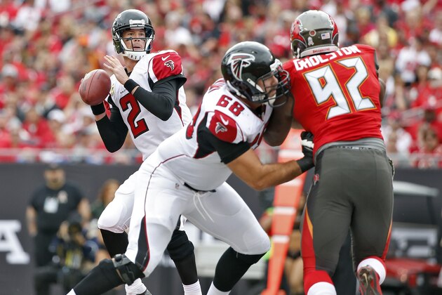 Atlanta Falcons quarterback Matt Ryan (2) looks to pass as teammate tackle Gabe Carimi (68) blocks Tampa Bay Buccaneers defensive end William Gholston (92) during the first quarter of an NFL football game Sunday, Nov. 9, 2014, in Tampa, Fla. (AP Photo/Brian Blanco)
