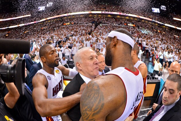 MIAMI, FL - JUNE 20: LeBron James #6 and Dwyane Wade #3 of the Miami Heat hug Head Coach Gregg Popovich of the San Antonio Spurs following the Heat's victory against the Spurs in Game Seven of the 2013 NBA Finals on June 20, 2013 at American Airlines Arena in Miami, Florida. NOTE TO USER: User expressly acknowledges and agrees that, by downloading and or using this photograph, User is consenting to the terms and conditions of the Getty Images License Agreement. Mandatory Copyright Notice: Copyright 2013 NBAE (Photo by Jesse D. Garrabrant/NBAE via Getty Images)