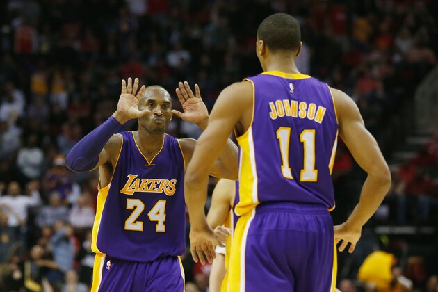 HOUSTON, TX - NOVEMBER 19:  Kobe Bryant #24 of the Los Angeles Lakers celebrates a play with Wesley Johnson #11during their game against the Houston Rockets at the Toyota Center on November 19, 2014 in Houston, Texas.  NOTE TO USER: User expressly acknowledges and agrees that, by downloading and/or using this photograph, user is consenting to the terms and conditions of the Getty Images License Agreement.  (Photo by Scott Halleran/Getty Images)