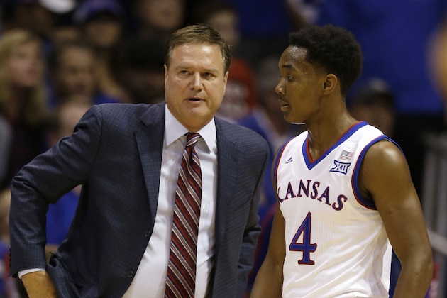Kansas head coach Bill Self, left, talks with Kansas guard Devonte Graham (4) during the first half of an NCAA exhibition college basketball game against Washburn in Lawrence, Kan., Monday, Nov. 3, 2014. (AP Photo/Orlin Wagner)