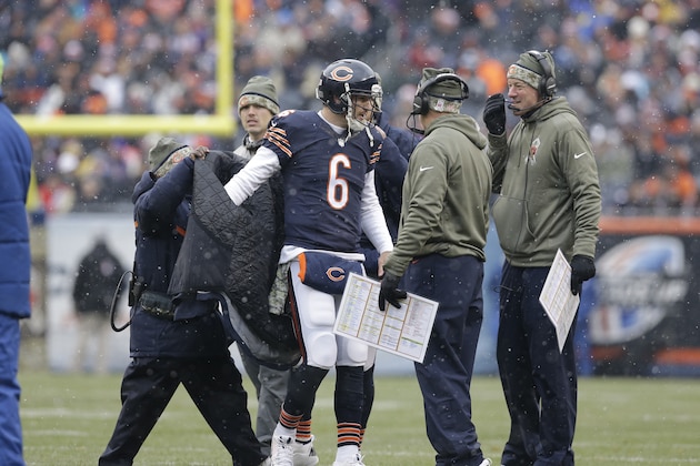 Chicago Bears quarterback Jay Cutler (6) puts a warm-up jacket on as he talks with coaches during the first half of an NFL football game against the Minnesota Vikings Sunday, Nov. 16, 2014 in Chicago. (AP Photo/Nam Y. Huh)