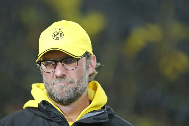 Dortmund's head coach Juergen Klopp grimaces during an interview prior to the German first division Bundesliga soccer match between BvB Borussia Dortmund  and VfL Borussia Moenchengladbach in Dortmund, Germany, Sunday, Nov. 9, 2014. (AP Photo/Frank Augstein)
