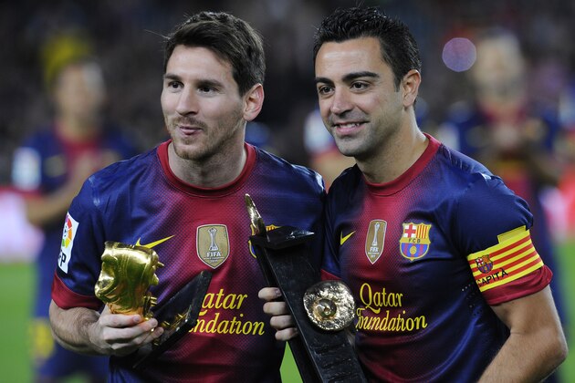 FC Barcelona's Lionel Messi from Argentina, left, hold the European Golden Boot 2012 award for best European goalscorer of the 2011-2012 season and Xavi Hernandez holds the Spain's prestigious Asturias prize before a Spanish La Liga soccer match a at the Camp Nou stadium in Barcelona, Spain, Saturday, Nov. 3, 2012. (AP Photo/Manu Fernandez)
