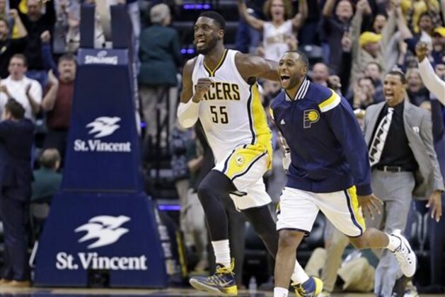 Indiana Pacers center Roy Hibbert, left, and guard A.J. Price run onto the court after the Pacers hit a last-second shot to defeat the Charlotte Hornets 88-86 in an NBA basketball game in Indianapolis, Wednesday, Nov. 19, 2014. (AP Photo/Michael Conroy)