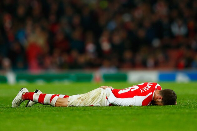 LONDON, ENGLAND - NOVEMBER 04:  Aaron Ramsey of Arsenal is injured during the UEFA Champions League Group D match between Arsenal FC and RSC Anderlecht at Emirates Stadium on November 4, 2014 in London, United Kingdom.  (Photo by Michael Regan/Getty Images)