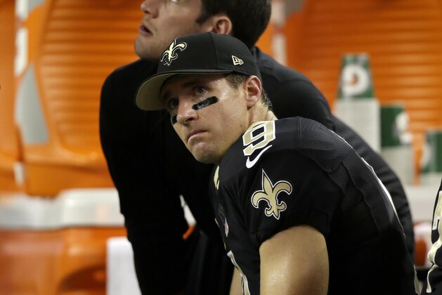 New Orleans Saints' Drew Brees sits on the sideline during the second half of an NFL football game against the Dallas Cowboys, Sunday, Sept. 28, 2014, in Arlington, Texas. (AP Photo/Tim Sharp)
