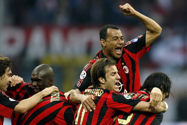 From left, AC Milan's Andrea Pirlo, Clarence Seedorf of the Netherlands, Alberto Gilardino, Serginho of Brazil and Alessandro Nesta celebrate after their teammate Kakha Kaladze of Georgia (covered) scored against Inter Milan during an Italian major league soccer match, at the San Siro stadium in Milan, Italy, Friday, April 14, 2006. (AP Photo/Luca Bruno)