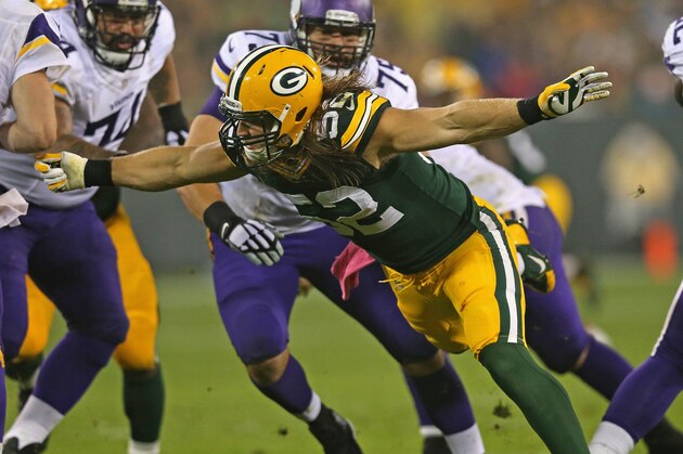 GREEN BAY, WI - OCTOBER 02:  Clay Matthews #52 of the Green Bay Packers pressures Christian Ponder #7 of the Minnesota Vikings at Lambeau Field on October 2, 2014 in Green Bay, Wisconsin. The Packers defeated the Vikings 42-10. (Photo by Jonathan Daniel/Getty Images)