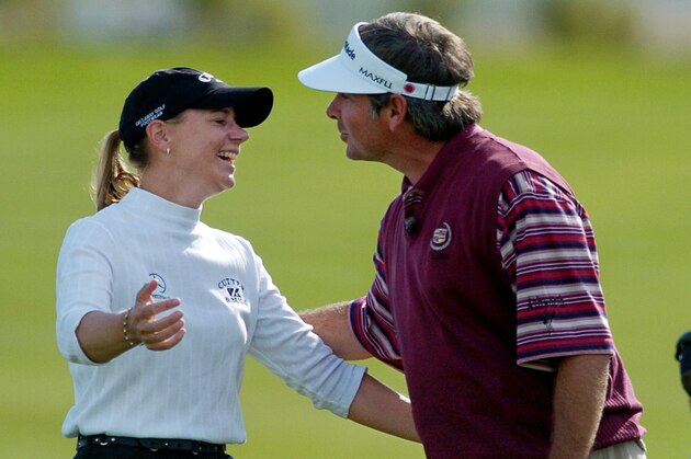 Annika Sorenstam, of Sweden, is kissed by Fred Couples after sinking a bunker shot for an eagle from 39 yards on the ninth hole, Saturday, Nov. 29, 2003, at the Skins Game in La Quinta, Calif. Sorenstam won $175,000 on the hole. (AP Photo/Mark J. Terrill)