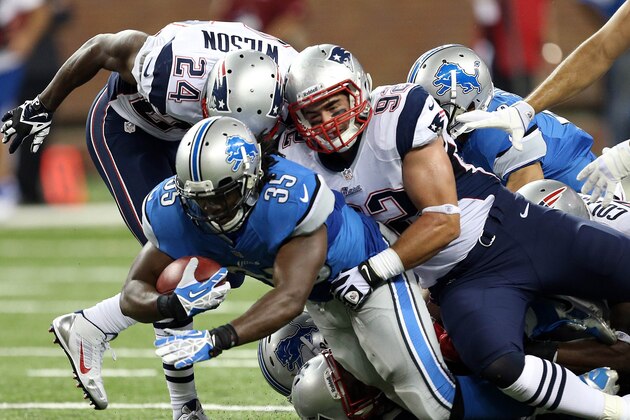 Aug 22, 2013; Detroit, MI, USA; Detroit Lions running back Joique Bell (35) is tackled by New England Patriots defensive end Jake Bequette (92) during 2nd half at Ford Field. Lions won 40-9.  Mandatory Credit: Mike Carter-USA TODAY Sports