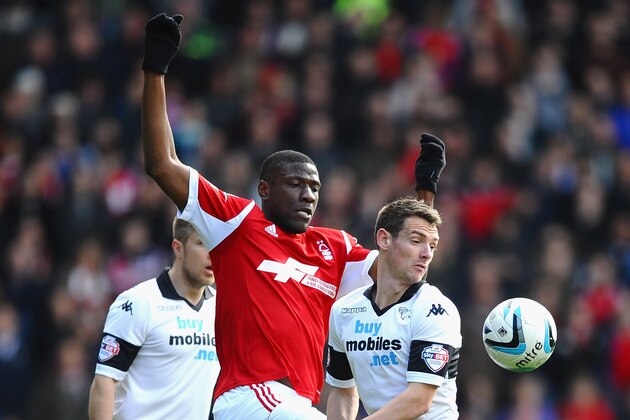 DERBY, ENGLAND - MARCH 22: Guy Moussi of Nottingham Forest battles with Craig Bryson of Derby County during the Sky Bet Championship match between Derby County and Nottingham Forest at iPro Stadium on March 23, 2014 in Derby, England.  (Photo by Laurence Griffiths/Getty Images)