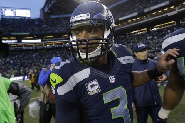 Seattle Seahawks quarterback Russell Wilson walks on the field after the team beat the New York Giants in an NFL football game, Sunday, Nov. 9, 2014, in Seattle. (AP Photo/Elaine Thompson)