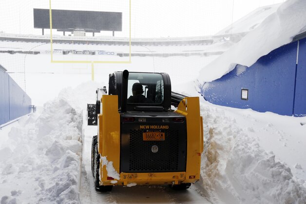 Nov 20, 2014; Orchard Park, NY, USA; After a major snow storm contractor Mike Abramo of Buffalo begins to clear snow from the football field at Ralph Wilson Stadium. Mandatory Credit: Kevin Hoffman-USA TODAY Sports
